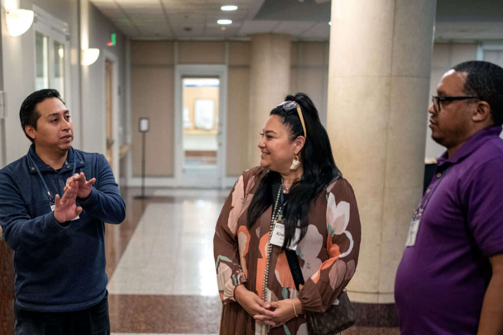 Three adults in a discussion